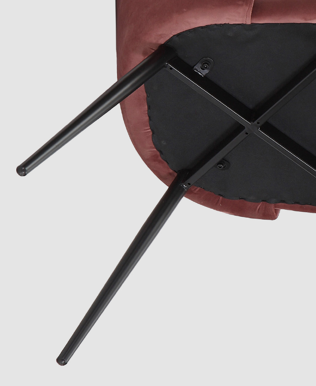 The underside of a dining chair with black powder-coated steel legs that have been splayed for stability.