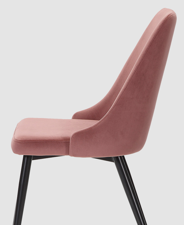 Side profile of a dining chair with a mid-height backrest and blush pink velvet upholstery.
