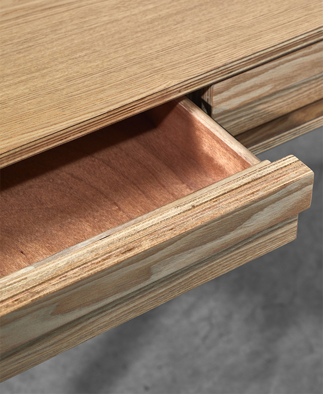 One shallow drawer is open. It's smoothly finished. The long handle on the front extends across its whole width.