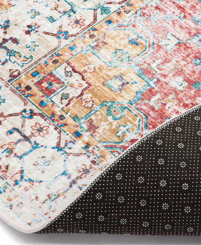 One edge of the rug is folded over, revealing the non-slip backing grip on the underside.