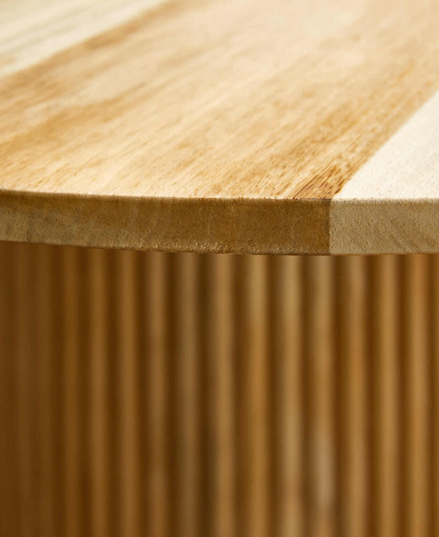 The table top's straight edge is seen, along with the wood's natural grains.