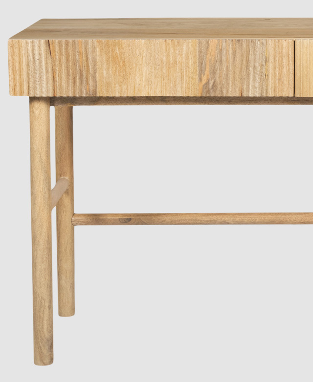 A mango wood desk with a slender top and round legs. The solid wood features natural tonal variations.