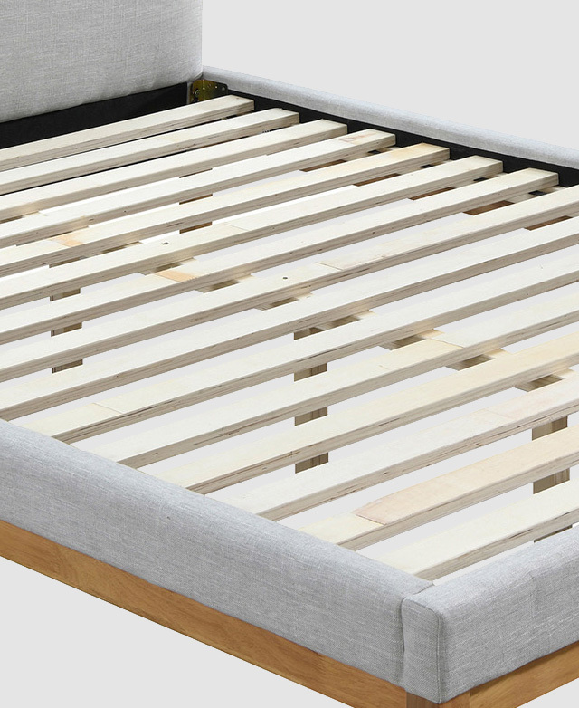 Flat plywood slats are affixed to either end of the bed frame, and supported by a central beam underneath. Flat plywood slats are affixed to either end of the bed frame, and supported by a central beam underneath.