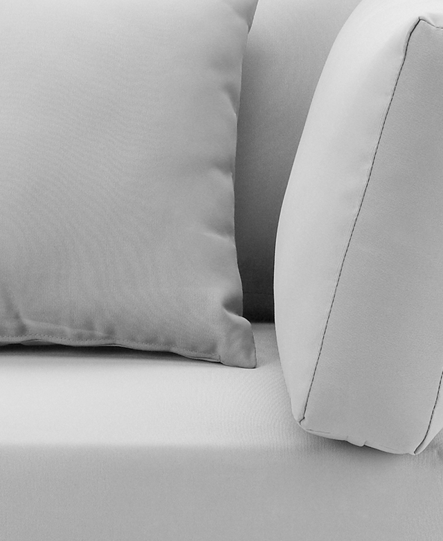 Close-up of its plump and generously padded seat cushions, with grey polyester upholstery.