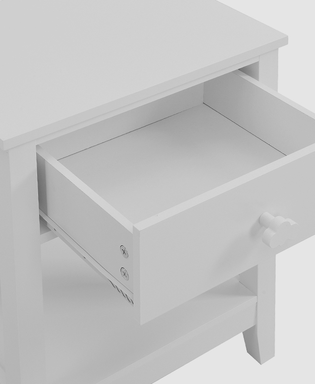 The top drawer of a white bedside table is pulled open, revealing its spacious depth and functional steel runners on the side.