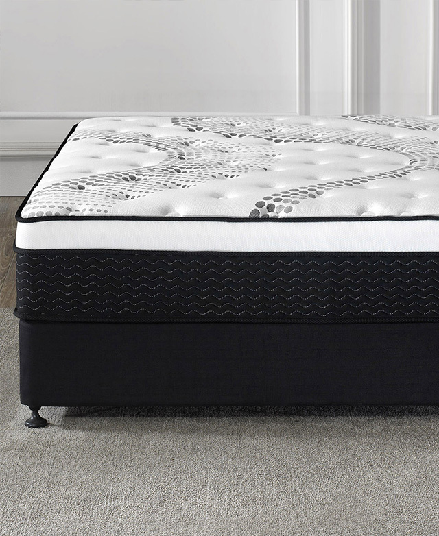 We're presented with the mattress on an upholstered base from a side angle, highlighting its depth.