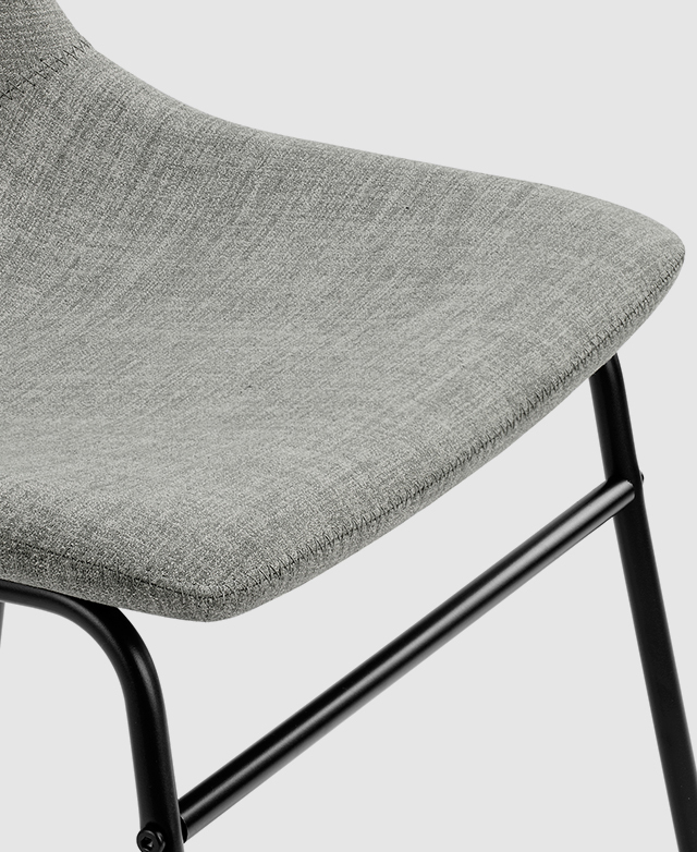 Close view of the grey polyester upholstery on the dining chair seat. It is gently padded with foam. Close view of the grey polyester upholstery on the dining chair seat. It is gently padded with foam.
