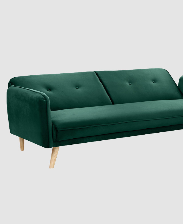 Most of the length of the emerald green sofa is in shot, with the backrest partially reclined.