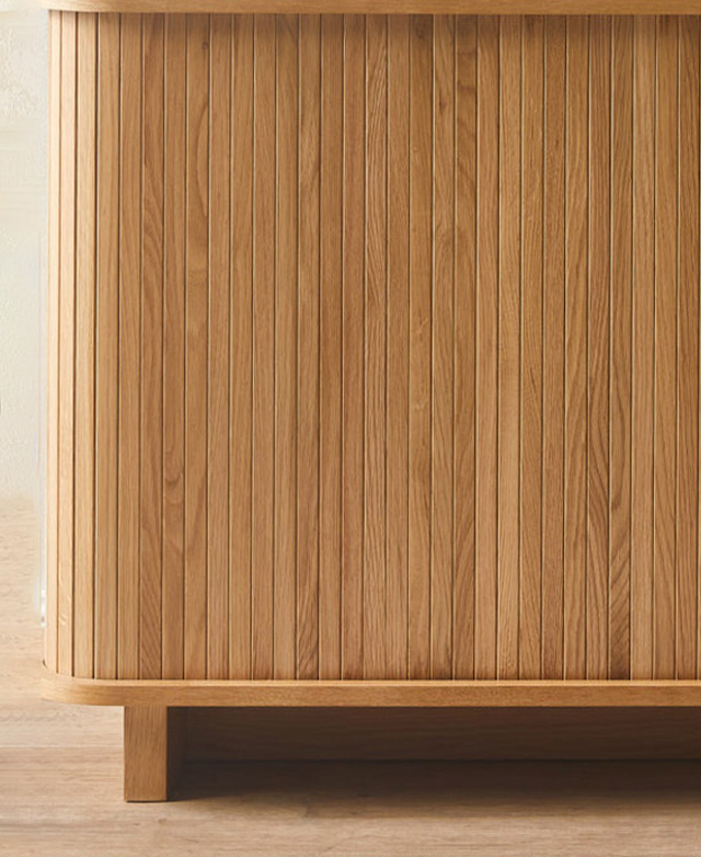 Close up is the tambour door front, which has even panelling in a warm timber colour.