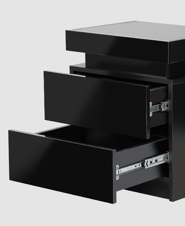 The two drawers of the side table are slightly pulled out, exposing the metal runners on the side. The two drawers of the side table are slightly pulled out, exposing the metal runners on the side.