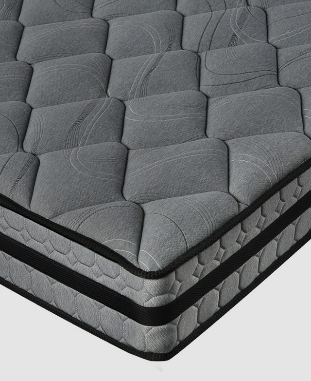 Bottom corner of the mattress shows the reinforced edges and black piping trim stabilising its structure.