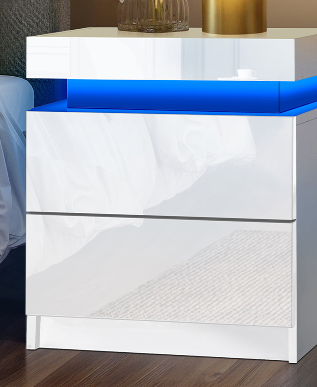 Adjacent to a bed and with decor items styled on top, the bedside table's boxy silhouette is emphasised. Adjacent to a bed and with decor items styled on top, the bedside table's boxy silhouette is emphasised.