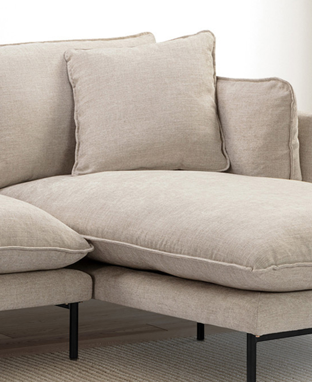 The seat of the chaise is shown at eye-level, displaying its lofty fill. A plump cushion is positioned against the backrest. The seat of the chaise is shown at eye-level, displaying its lofty fill. A plump cushion is positioned against the backrest.