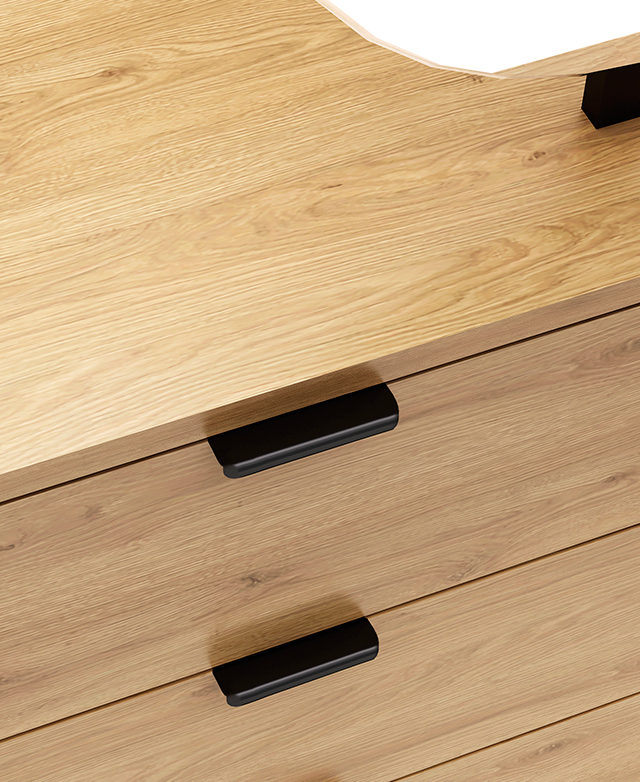 Black tab handles of the drawers are displayed, and the grainy look of the melamine finish is shown.