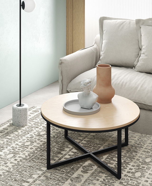 A stone bust, a concrete tray & a terracotta vase are arranged on the table, which is on a rug, next to a neutral sofa. A stone bust, a concrete tray & a terracotta vase are arranged on the table, which is on a rug, next to a neutral sofa.