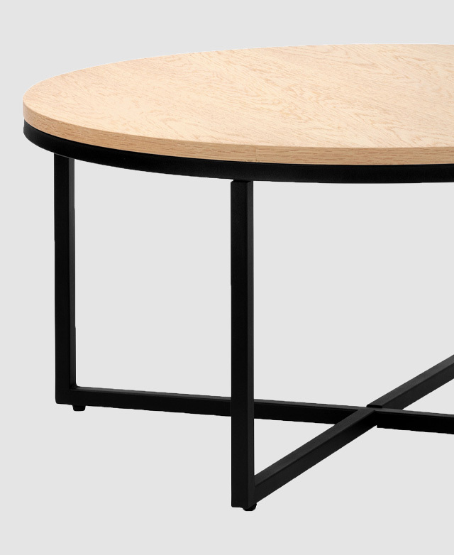 The geometric, black, metal base is in focus, showing the open space beneath the top. The geometric, black, metal base is in focus, showing the open space beneath the top.
