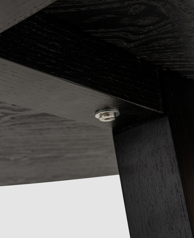 The angular base is attached underneath the table top by screws.