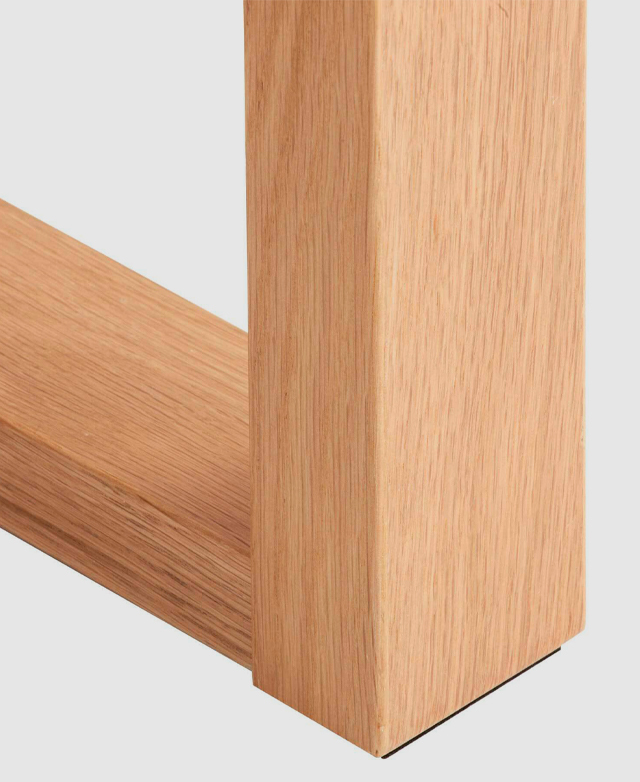 One corner of the ski-leg is shown, highlighting the typically straight wood grain of its oak veneer finish.