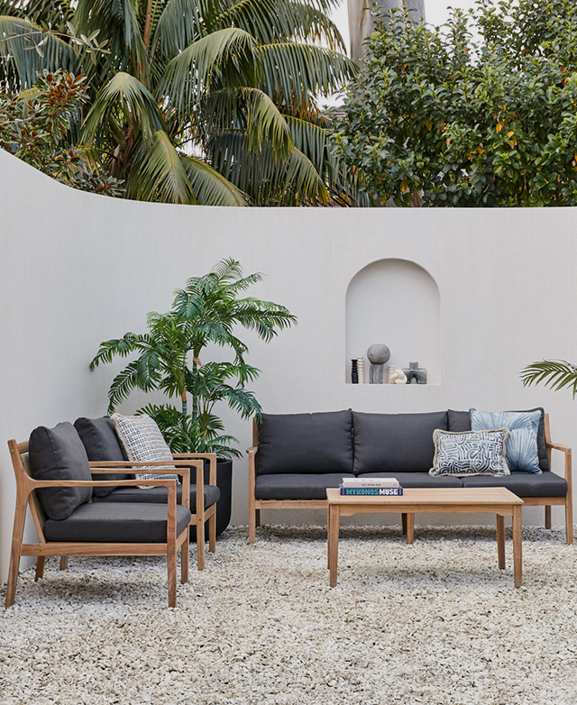 The complete furniture set is shown in front of a curved concrete wall, next to tropical foliage, on top of cool gravel. The complete furniture set is shown in front of a curved concrete wall, next to tropical foliage, on top of cool gravel.