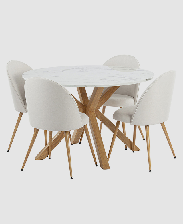 Four white dining chairs are positioned around the round dining table. Four white dining chairs are positioned around the round dining table.