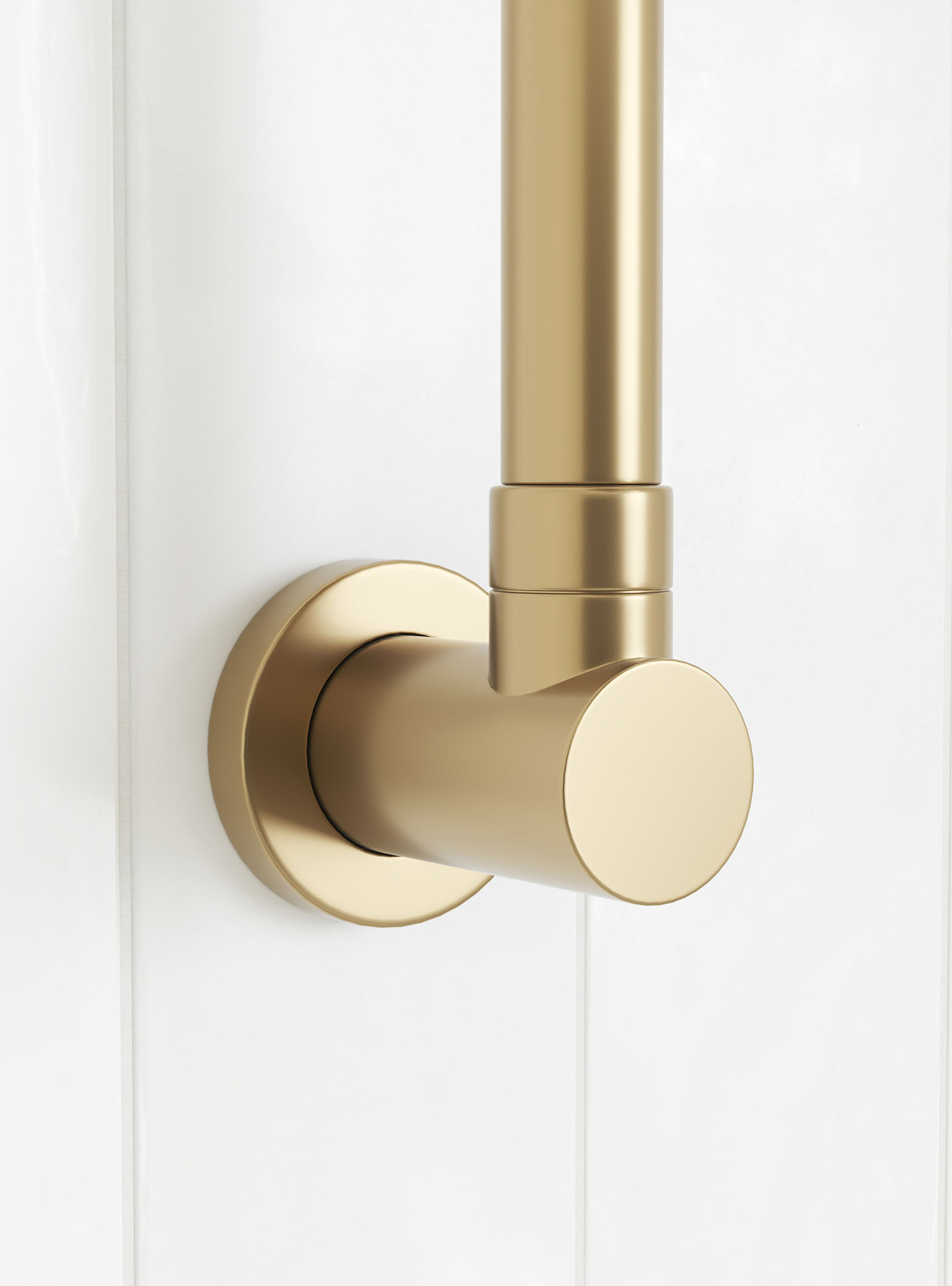 Close-up of brushed gold shower bracket against a white tiled wall Close-up of brushed gold shower bracket against a white tiled wall
