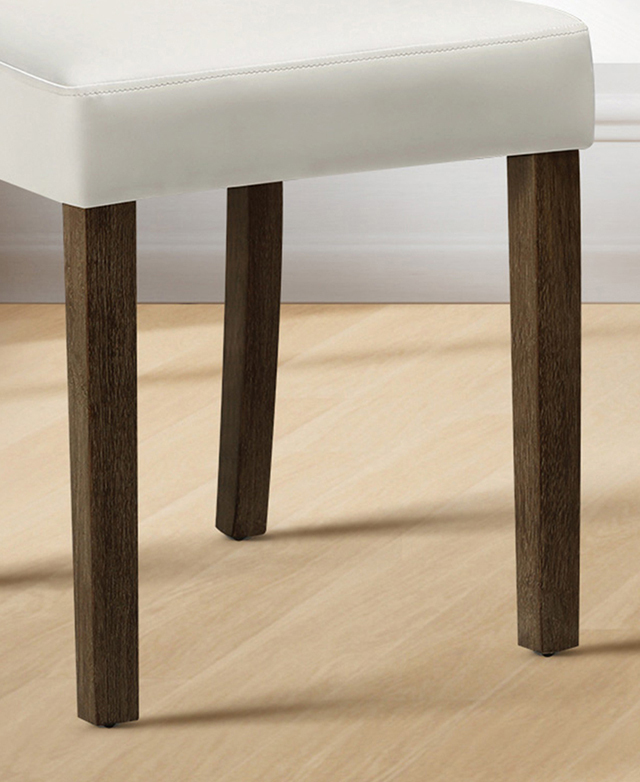Dark-toned angular rubberwood dining chair legs on a light timber floor. Dark-toned angular rubberwood dining chair legs on a light timber floor.