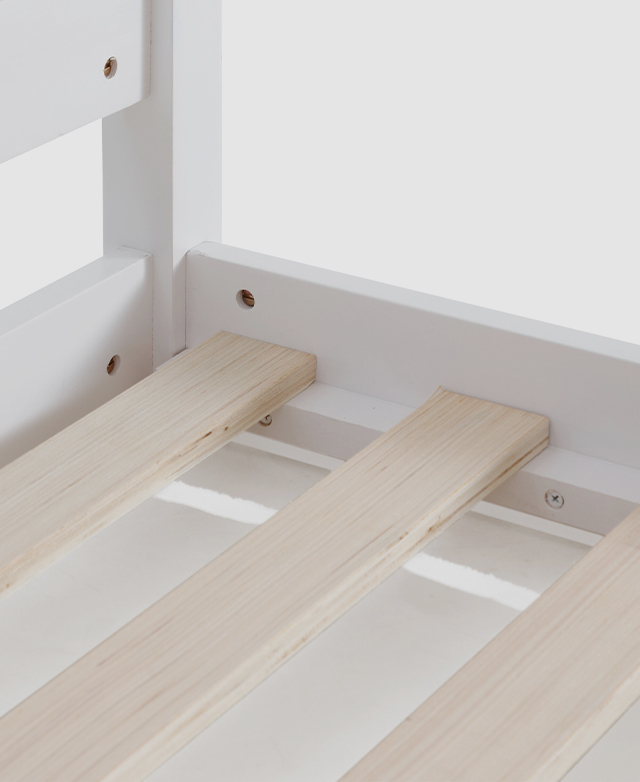 Close view of a slatted base and the white bed frame it sits within. Close view of a slatted base and the white bed frame it sits within.