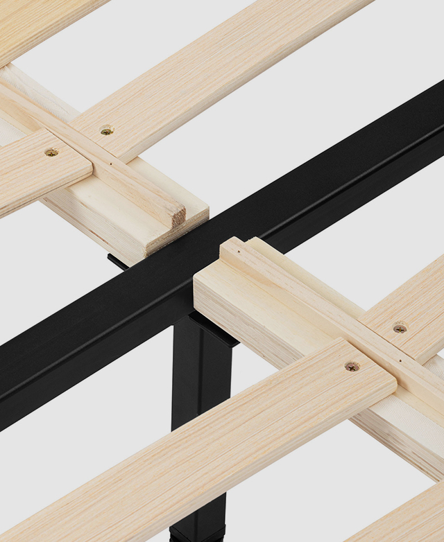 Plywood and black metal mattress support has evenly spaced gaps for breathability.