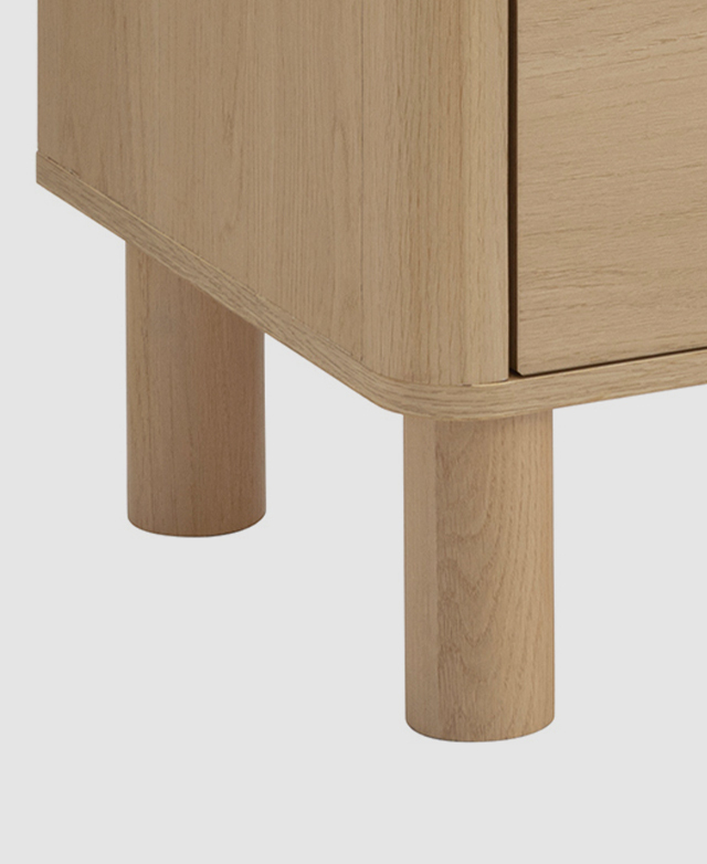 Two of the thick cylindrical pine wood legs are in focus. Two of the thick cylindrical pine wood legs are in focus.