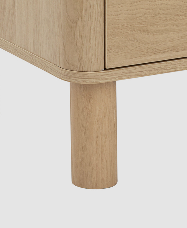 A pine wood cylindrical leg is in focus A pine wood cylindrical leg is in focus