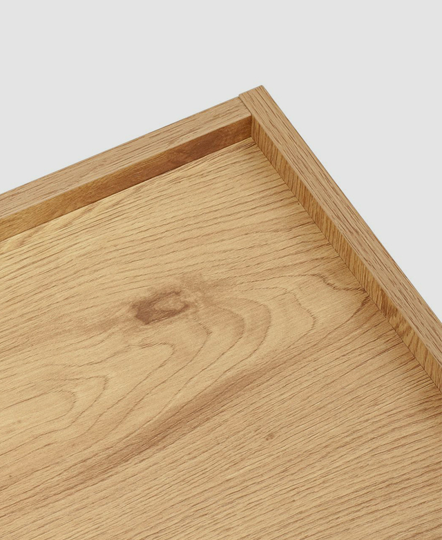 Top-down view of the raised edges of the bedside table. Top-down view of the raised edges of the bedside table.