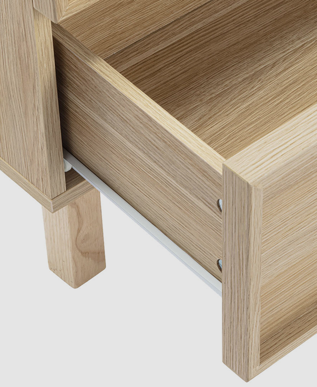Bird's-eye view of a single drawer partially open shows a white metal runner. Bird's-eye view of a single drawer partially open shows a white metal runner.