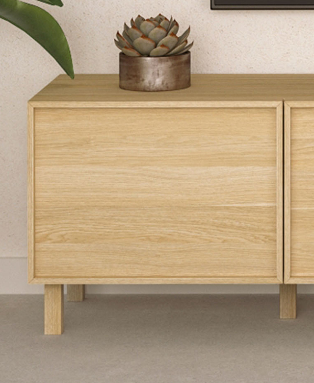 The entertainment unit is styled in a neutral room with a cactus on top, with the shaker cupboard door on display. The entertainment unit is styled in a neutral room with a cactus on top, with the shaker cupboard door on display.