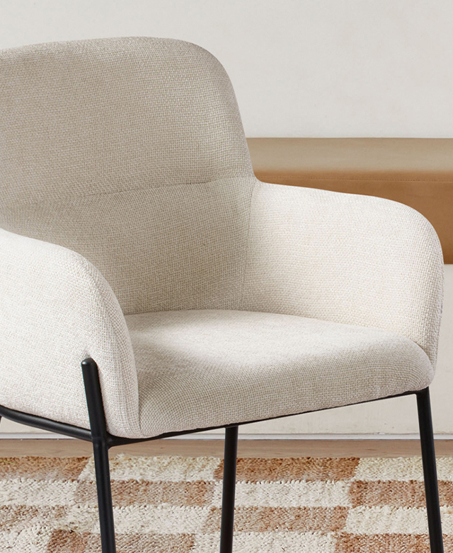 Cropped view of the cream armchair highlights the rounded, foam-filled corners and edges.