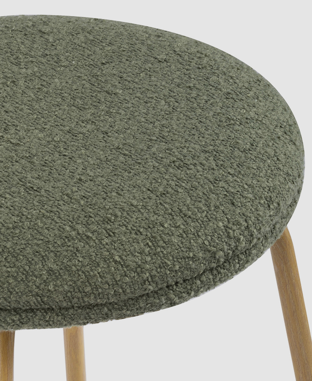 Close-up of the round, green boucle stool seat.