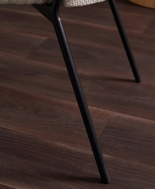 Two sleek black tubular iron legs are in the frame.