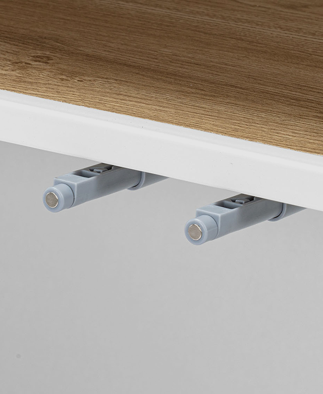 Close up of the magnetic points of closure that keep the cupboard doors shut.
