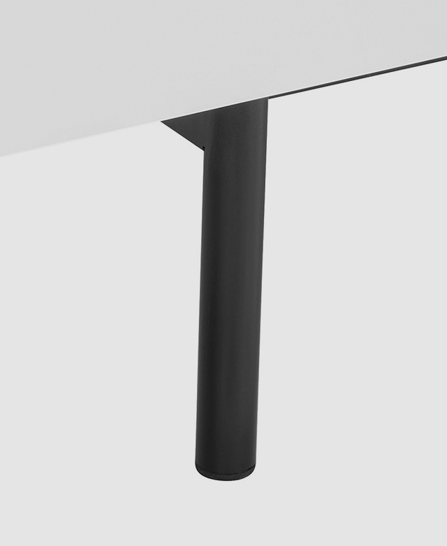 Cylindrical black steel leg is magnified; it contrasts against the white body of the unit.