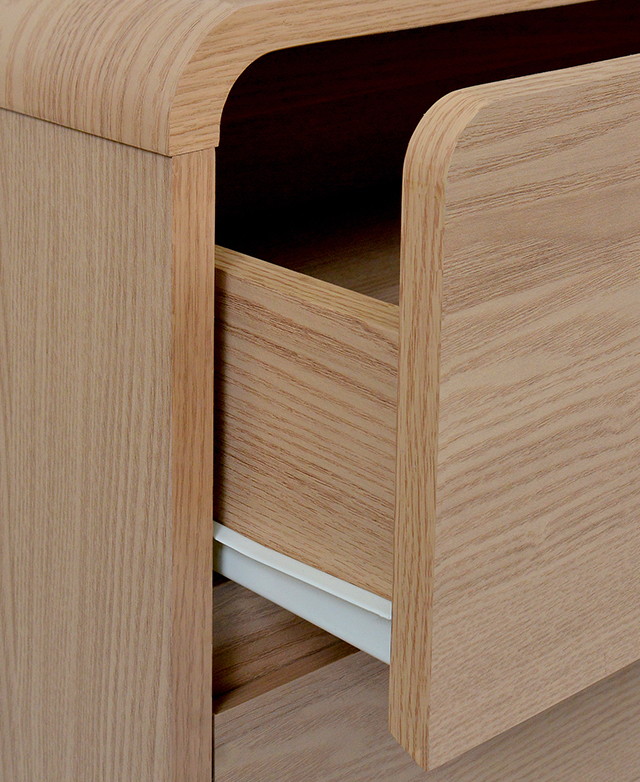 Three-quarter view of an open drawer draws attention to the white iron runner.