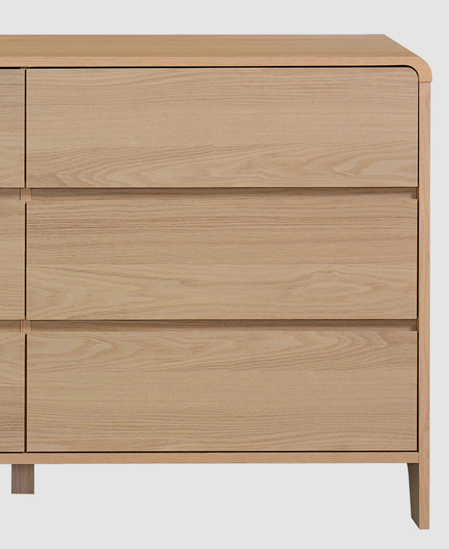 Cropped front-facing view of the chest shows the wood-look laminate surfaces. Cropped front-facing view of the chest shows the wood-look laminate surfaces.