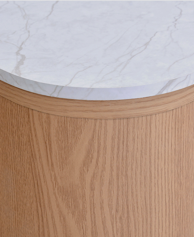 Close view of the bedside table highlights a smooth, deeply-rounded corner of the faux marble top. Close view of the bedside table highlights a smooth, deeply-rounded corner of the faux marble top.