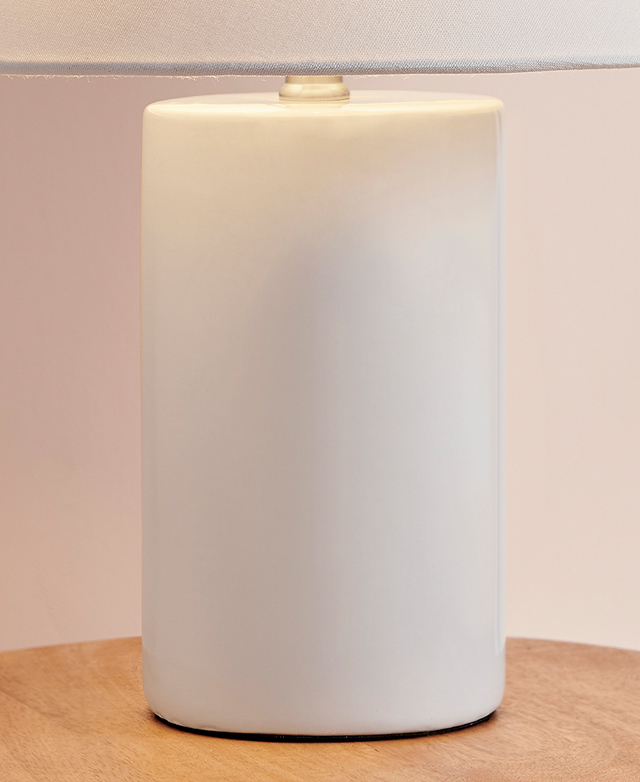 The white cylindrical lamp base has a high-shine finish. The white cylindrical lamp base has a high-shine finish.