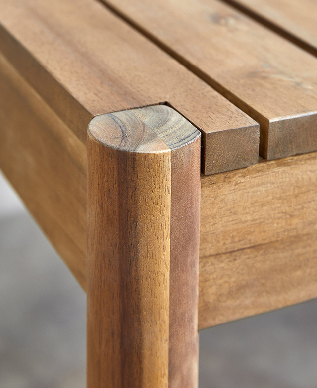 A spotlight on the timber, which illuminates the natural grain patterns and rich tones.