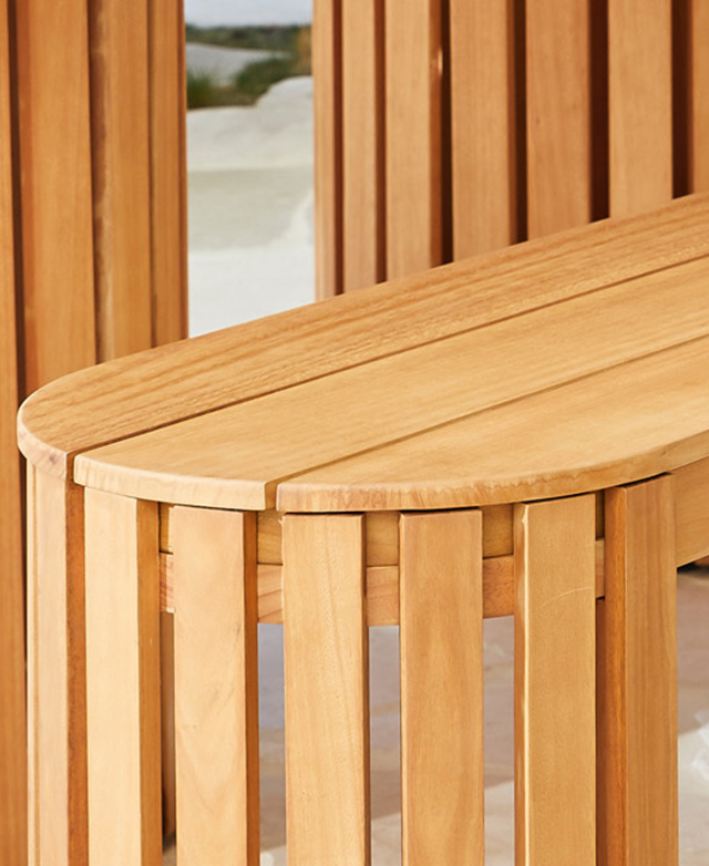 Broad slats on the top of the bench and slimmer vertical ones make up the semi-circular leg design. Broad slats on the top of the bench and slimmer vertical ones make up the semi-circular leg design.