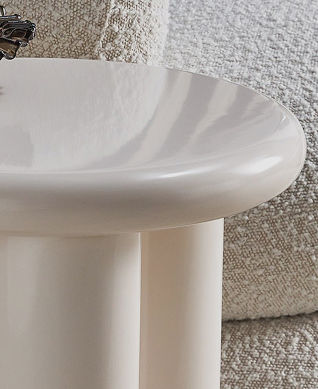 The crisp, glossy white side table is positioned in front of soft cream boucle furniture. The crisp, glossy white side table is positioned in front of soft cream boucle furniture.