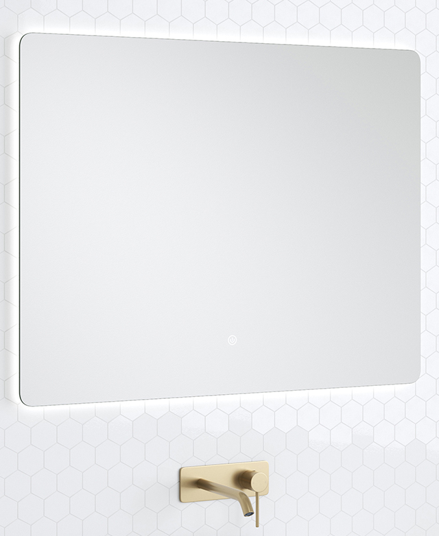 The rectangular mirror is illuminated by a discreet LED strip, and fixed against a white tiled bathroom wall.