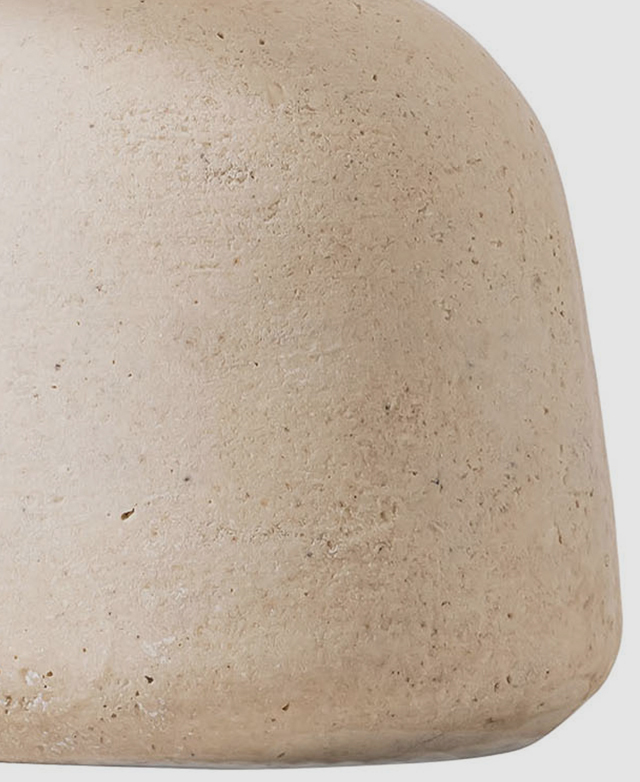 The matte grey tones of the table lamp base are shown up close.