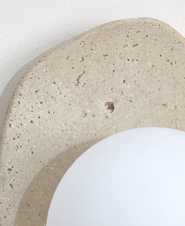 The speckled effect and smooth and irregular edge of the cast stone are depicted.