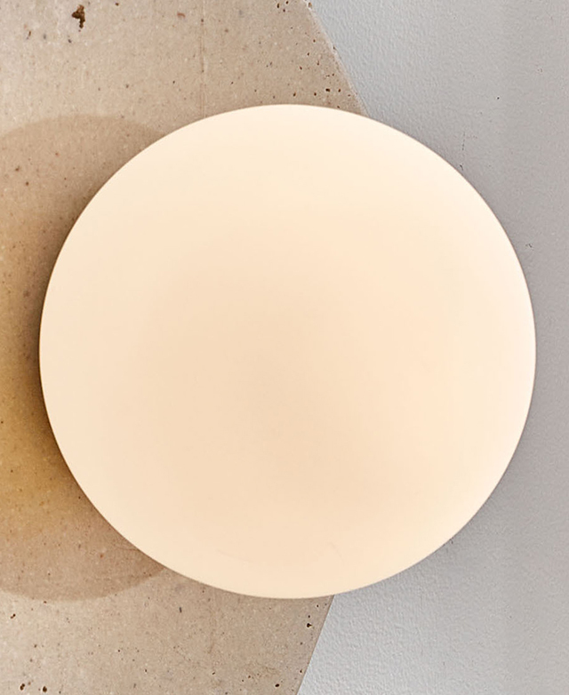 A bulb is on behind the frosted glass spherical shade, showing a soft glow.