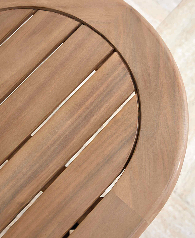 A top-down angle of the acacia wood bench highlights the rounded end, smooth finishes, and slatting. A top-down angle of the acacia wood bench highlights the rounded end, smooth finishes, and slatting.
